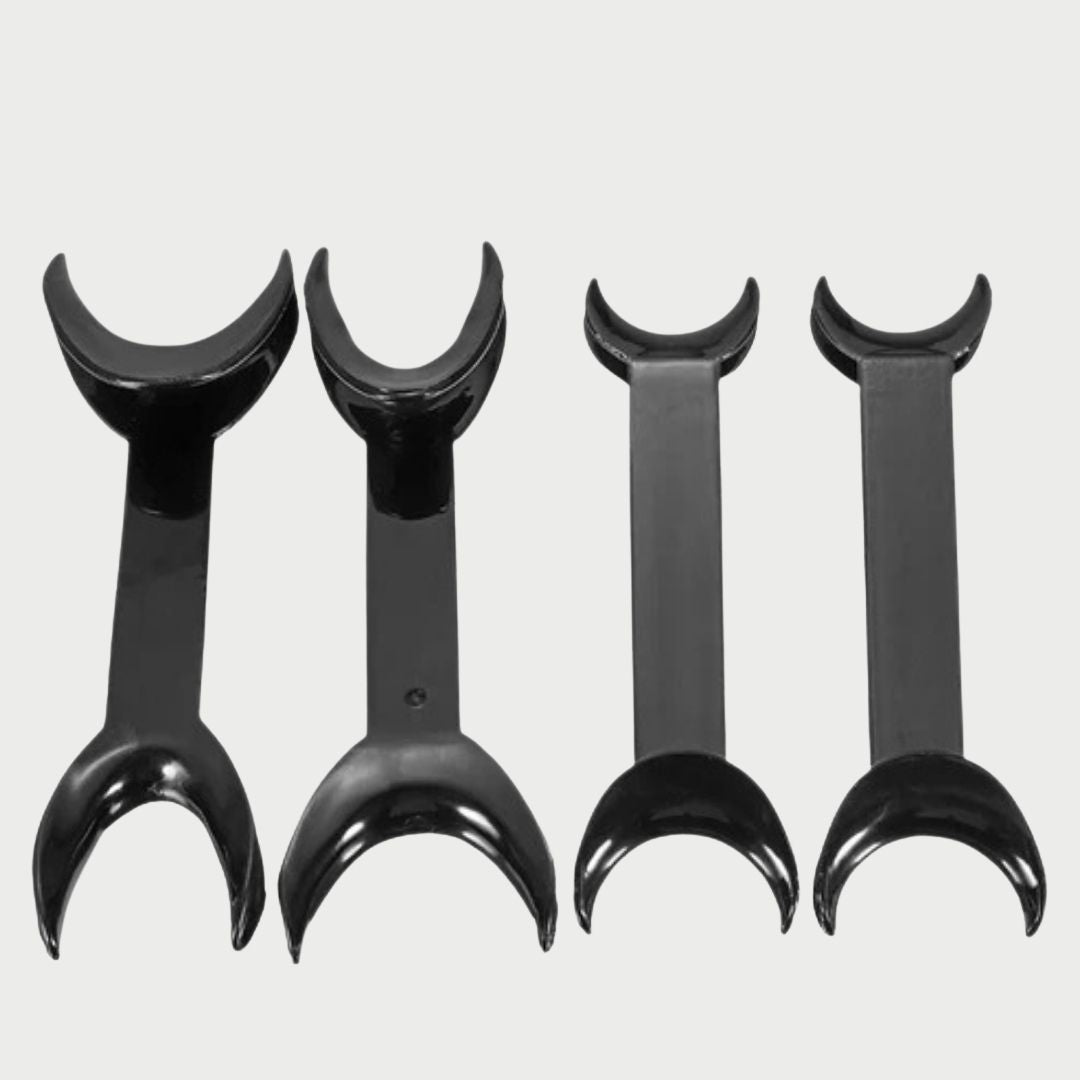 Four black plastic curved wall hooks arranged in descending sizes against a light gray background.