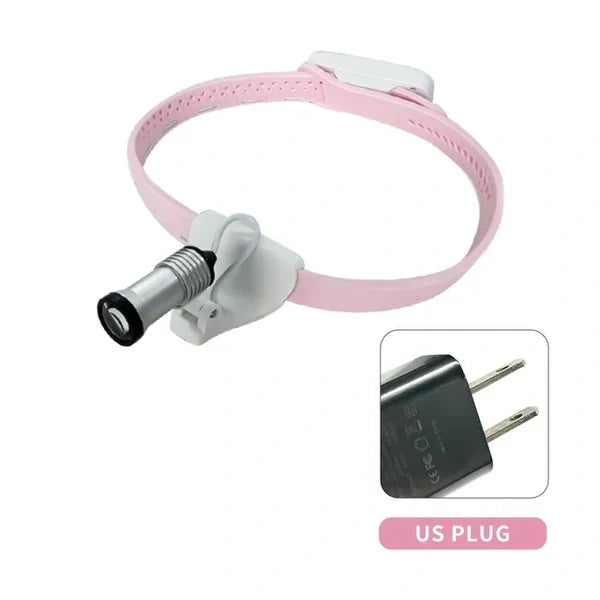 Portable dental LED headlamp in pink with US plug charger.