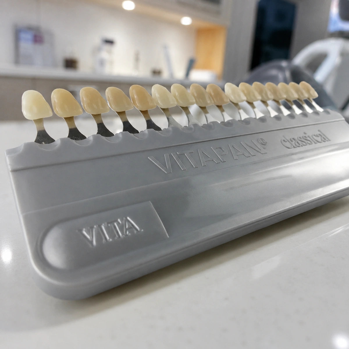 VITA Classical shade guide with 16 shade tabs on a dental clinic counter.