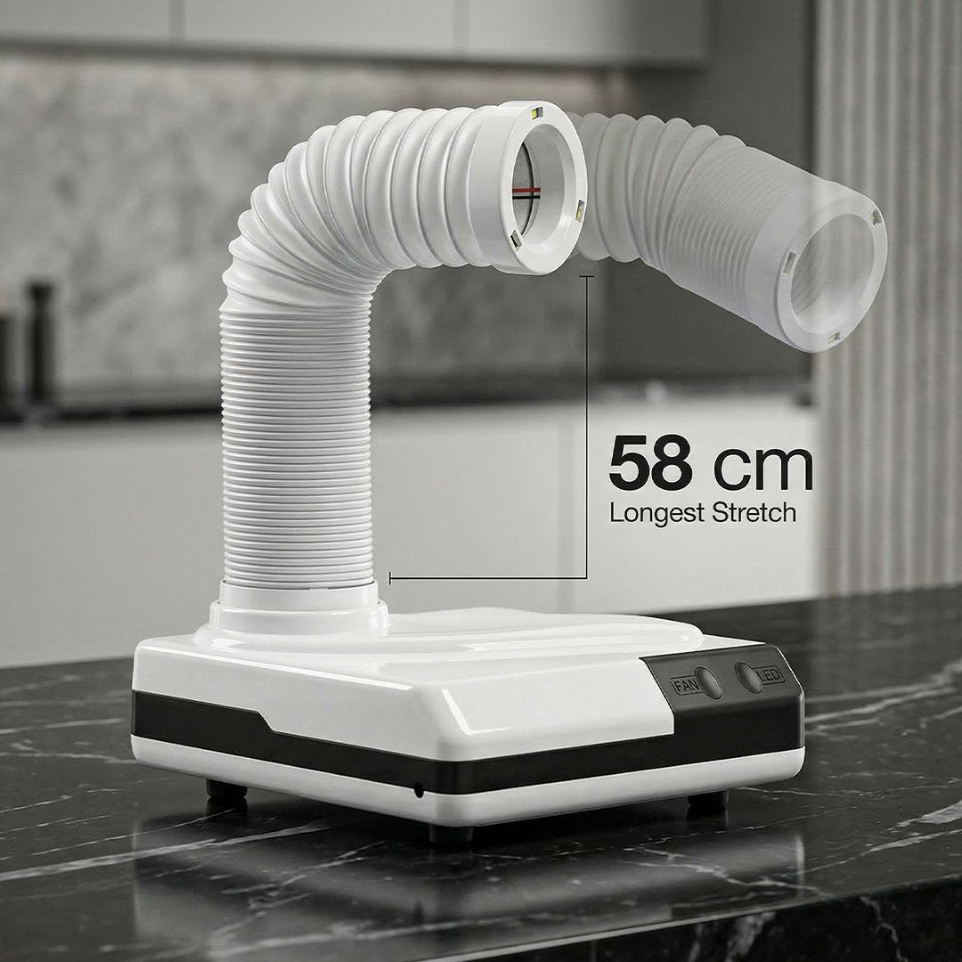 White kitchen exhaust hood with flexible duct on a marble countertop
