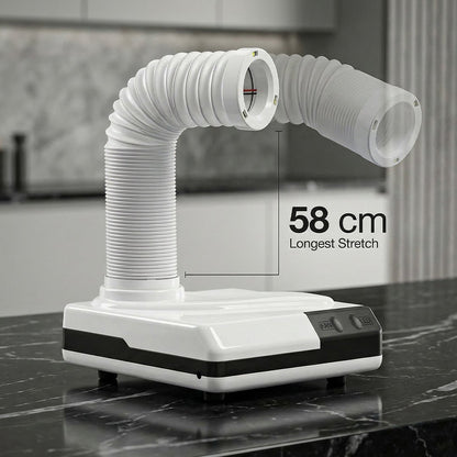 White kitchen exhaust hood with flexible duct on a marble countertop