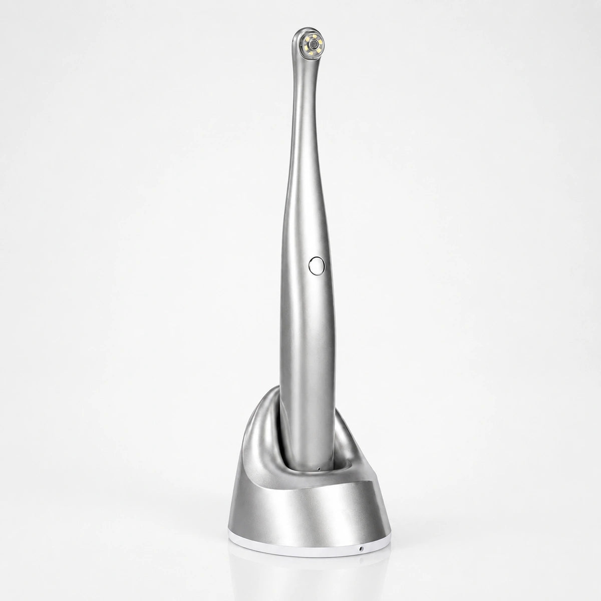 Cordless intraoral dental camera with LED lighting on charging base.