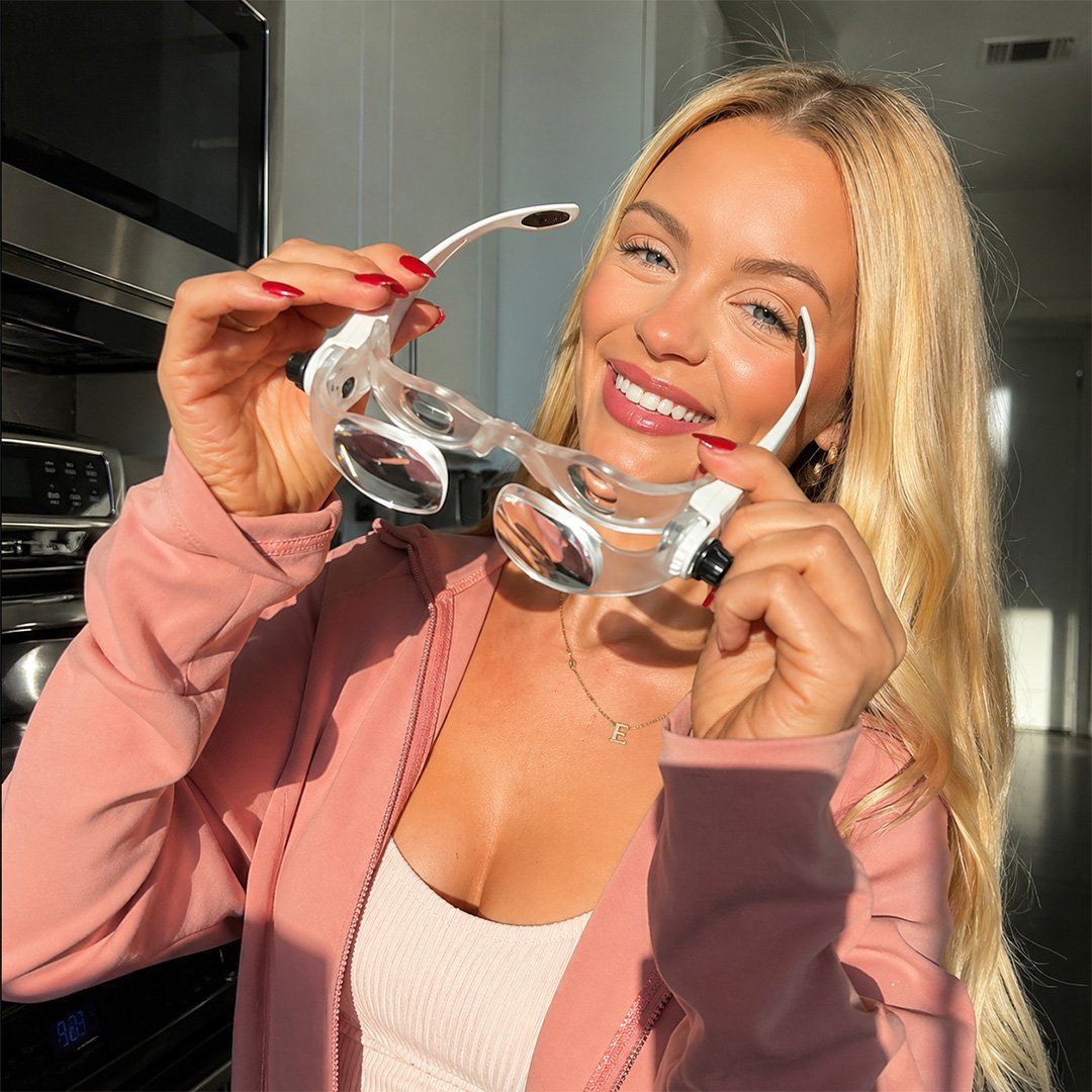 Woman holding a clear face mask in a Dental Setting